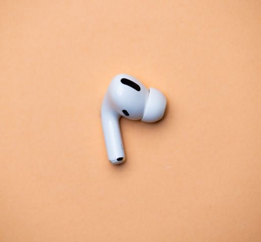 A White Wireless Headphones isolated on orange Background