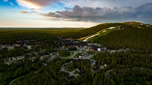 Aerial drone view of the Levi town, sunny summer evening with a rainbow in Lapland, Finland
