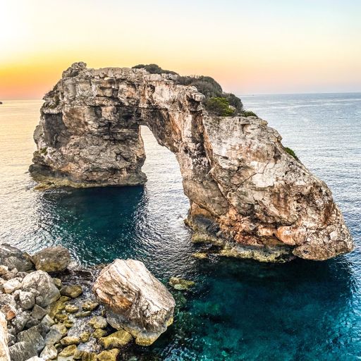 A scenic shot of The big bridge, a natural arch at sunset in Spain
