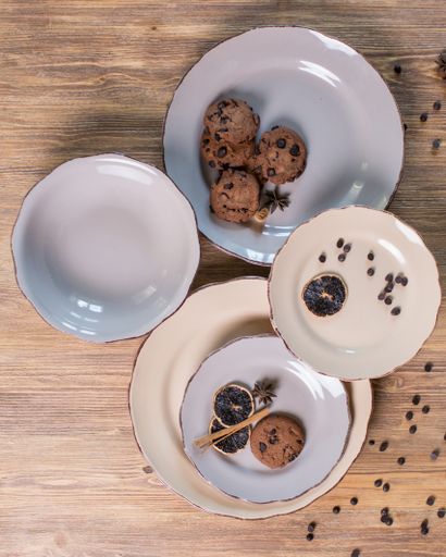 A top view of white dish set with chocolate chip cookies and seasonings