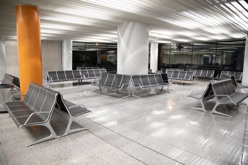 A view of empty waiting room of airport at night without people on seats