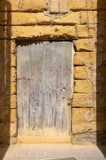 A vertical shot of an old vintage door of an ancient building in Victoria, Gozo, Malta