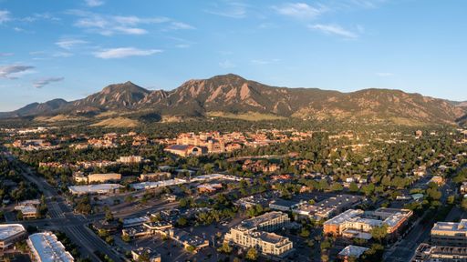 Morning sunrise photo of Boulder, Colorado. Highlights the city with a contrast on the mountains.