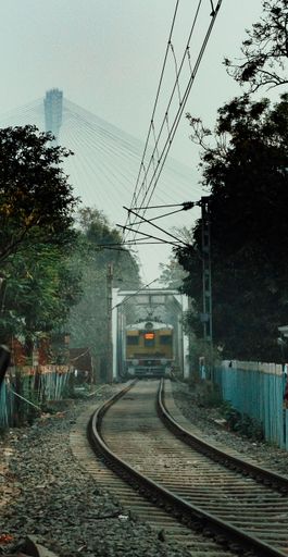 A vertical panoramic shot of a train on the tracks