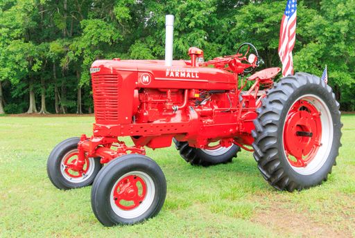 A shot of the red Farmall Tractor in the field, in United States