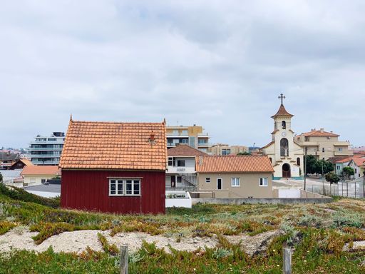 A scenic shot of buildings from a town in Portugal under a cloudy sky