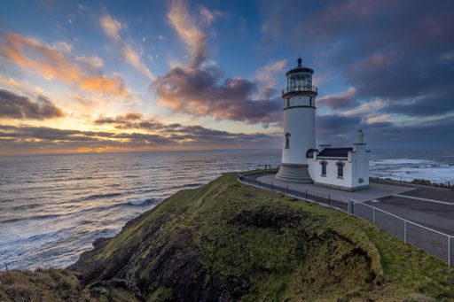 A beautiful shot of the North Head Lighthouse on a hill at sunset in Ilwaco, Washington