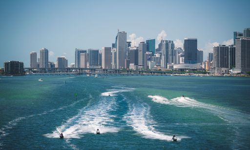 The skyline of Downtown Miami with motorboats on the water, Florida, USA