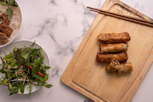 A high angle shot of Asian rolls on a wooden board