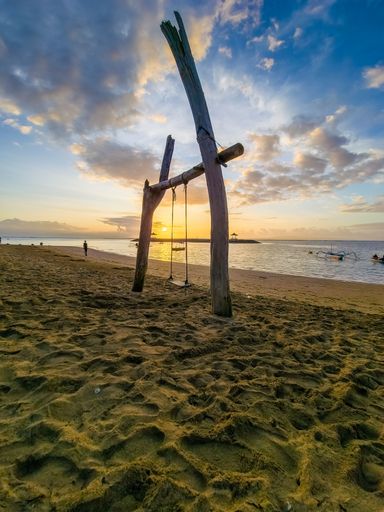 A mesmerizing view of the golden sunset over the sea in Sanur Beach Bali