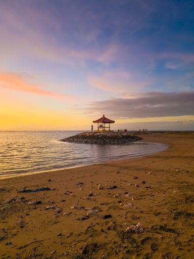 A mesmerizing view of the golden sunset over the sea in Sanur Beach Bali