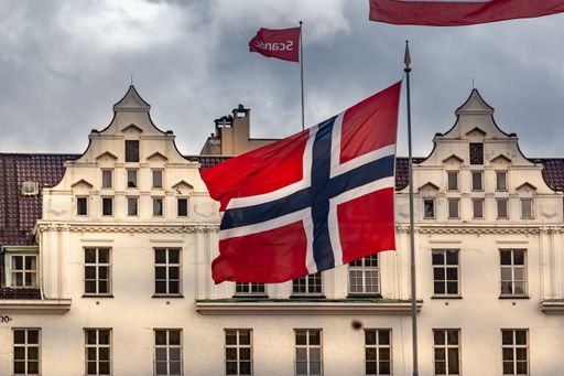 The Norway flag and the facade of a historical building in Bergen, Norway