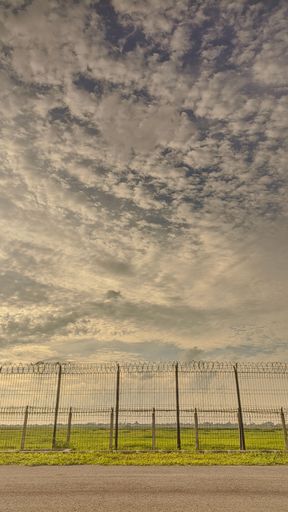 A beautiful shot of iron border fencing under the cloudy sky