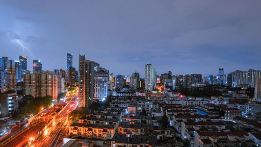 An amazing shot of Shanghai city landscape during night thunderstorm with lightning and cloudy sky