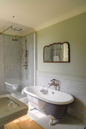 An interior of a bathroom with shower and bathtub