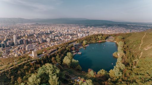 An aerial view of Turtle Lake with the Tbilisi cityscape in the background in Georgia