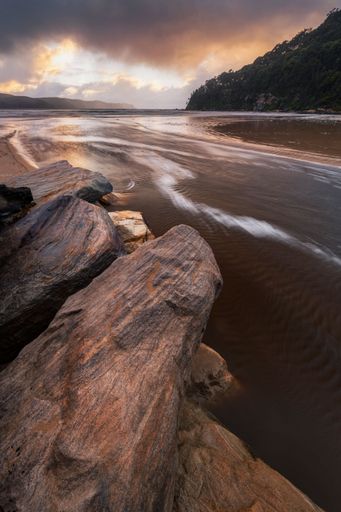 The water rushing out from the creek at umina beach on the Central Coast, NSW in Australia