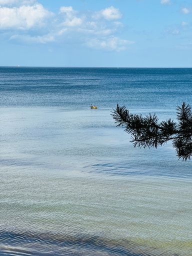 A vertical view of a sandy beach of the Baltic Sea on a sunny day in Orlowo, Kolibki, Gdynia, Poland