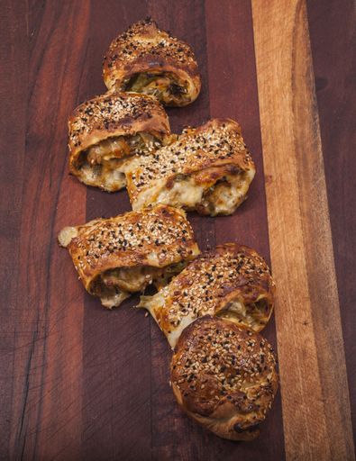 A vertical high angle shot of a delicious homemade pizza on a wooden board