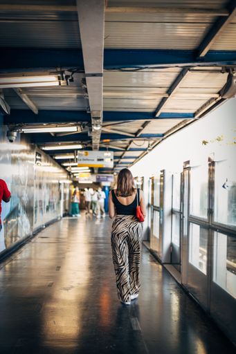 A vertical shot of a young lady walking in airport in Sevilla, Spain