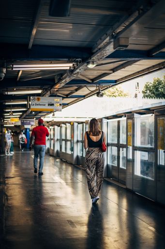 A vertical shot of a young lady walking in airport in Sevilla, Spain