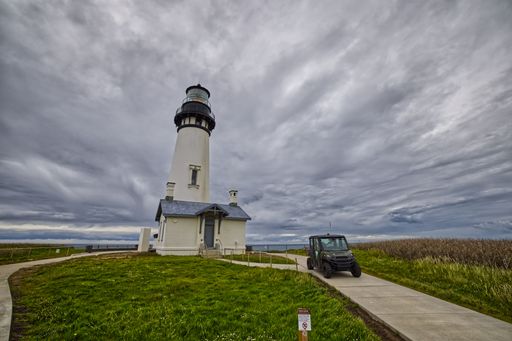 The Yaquina Head Lighthouse from the movie The Ring in captured with a parked car next to it in Oregon
