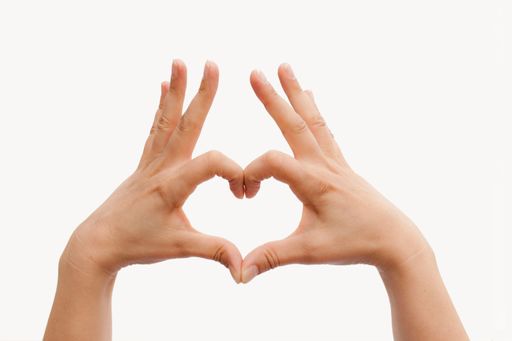 A closeup shot of a person's hand making a heart isolated on a white background