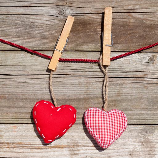 An overhead shot of heart shaped decorations for Valentine's day on a wooden surface