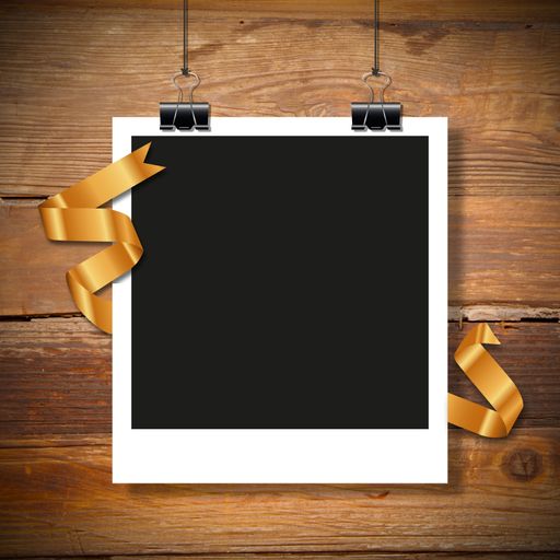 A closeup shot of a polaroid frame with copy space on a wooden background