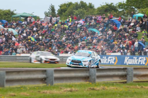 A British Touring Car on the track at Thruxton with blurred background, panning effect