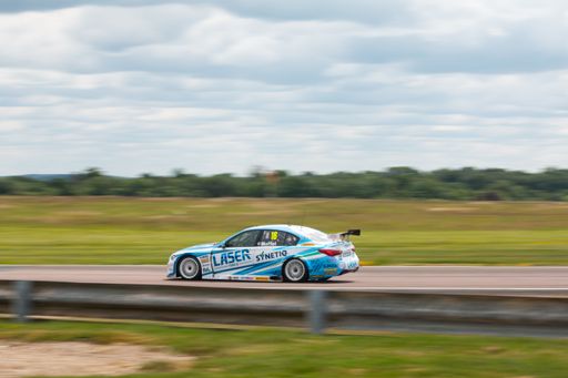 A British Touring Car on the track at Thruxton with blurred background, panning effect