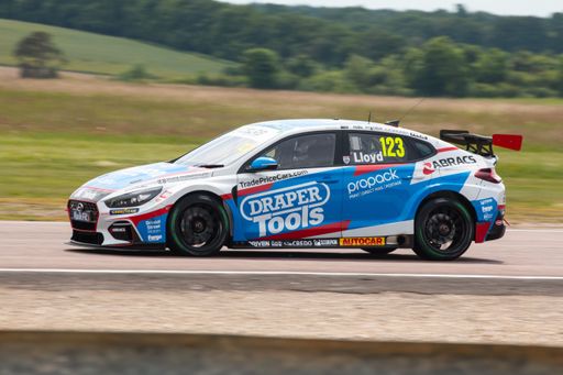 A British Touring Car on the track at Thruxton with blurred background, panning effect