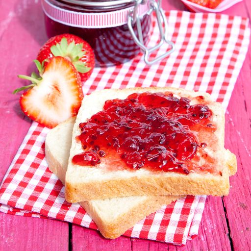 A closeup shot of toasted bread with strawberry jam