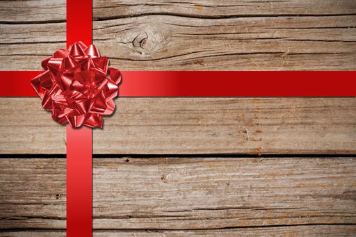 A closeup shot of a red bow on wood background