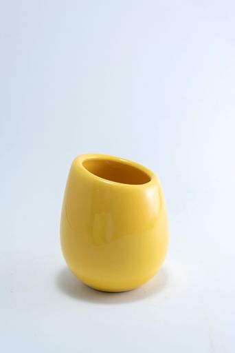 A vertical shot of a yellow cup isolated on the white background