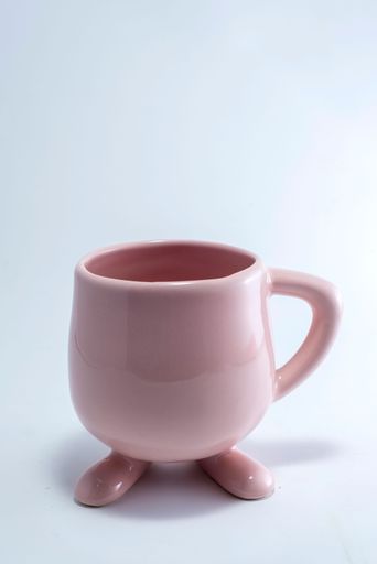 A vertical shot of a pink cup isolated on the white background