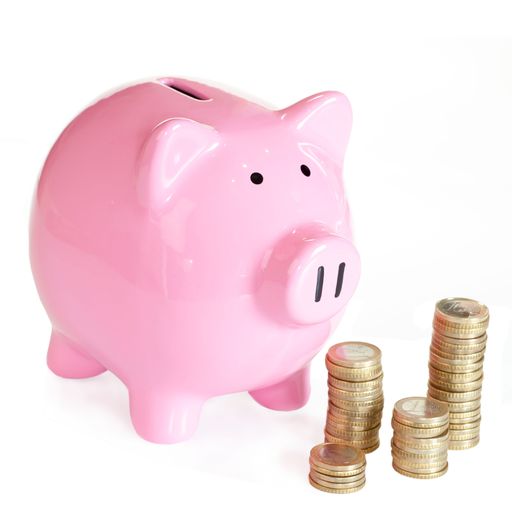 A closeup shot of a piggy bank with coins on a white background
