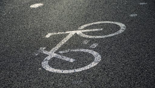 A close up shot of a white bicycle sign on asphalt in the streets of Belem, Portugal