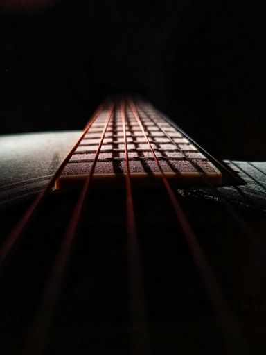 This is a photograph of an acoustic guitar with 6 strings.