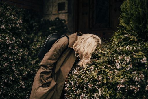 A shallow focus shot of blonde Caucasian in a park