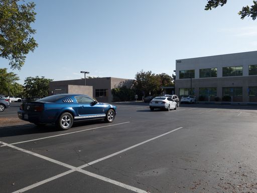 A Ford Mustang in parking lot of a medical center