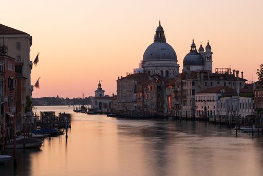 A stunning sunset view of the Grand Canal and old architecture in Venice, Italy