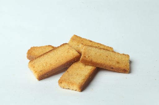 A closeup of piled rectangular pieces of bread on a white surface