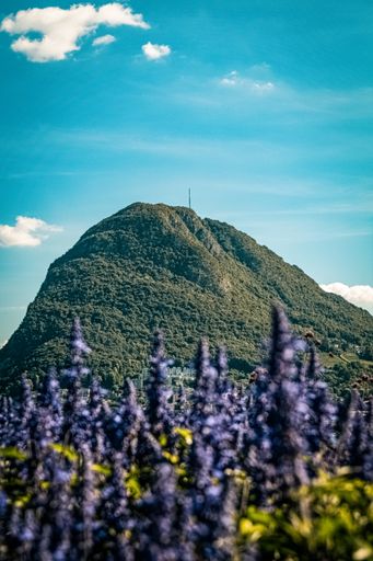 A scenic vertical shot of Mount Bre from Lake Lugano located in Lugano, Switzerland