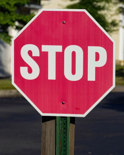 A vertical shot of the red stop sign