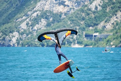 A male using an inflatable wing with a board on the lake Garda in Italy