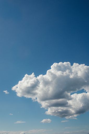 Fluffy white cumulus clouds against blue sky