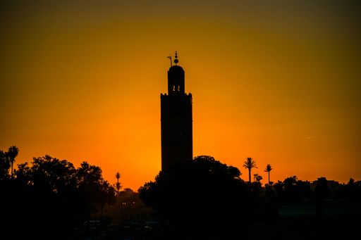 The silhouette of Koutoubia Mosque against a beautiful sunrise sky in Marrakech, Morocco