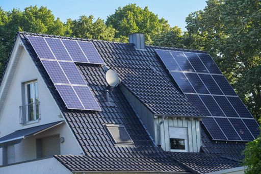 The view of a residential building with solar panels on its roof