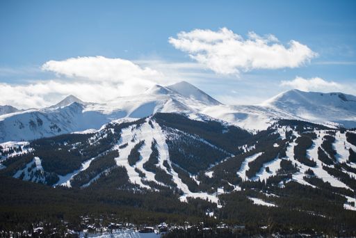 A beautiful shot of mountains partly covered in snow